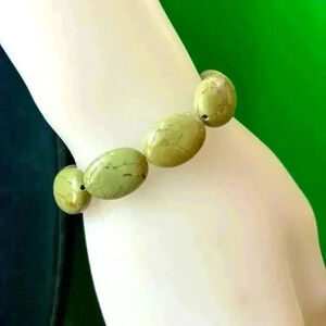 Turquoise, green stretchy bracelet, mannequin’s wrist is 6”